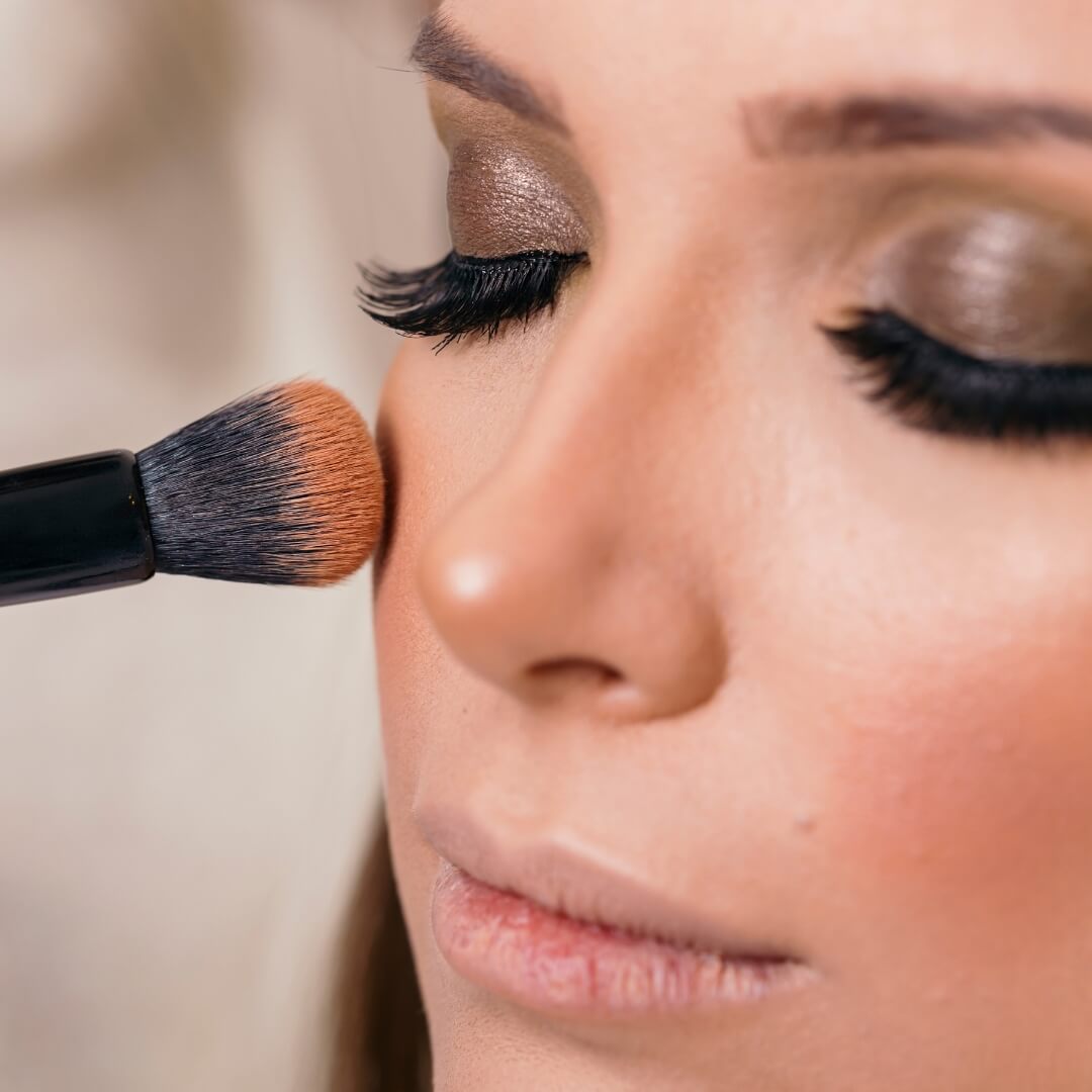 Founadtion brush being applied to a ladies face
