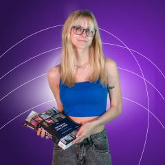 Blonde female student wearing glasses holding law books in front of purple background